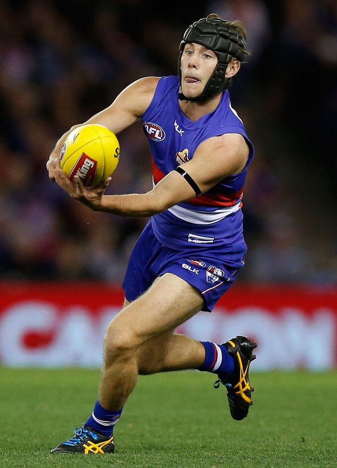 AFL 2015 Rd 20 - Western Bulldogs v Melbourne MELBOURNE, AUSTRALIA - AUGUST 16: Caleb Daniel of the Bulldogs handpasses the ball during the 2015 AFL round 20 match between the Western Bulldogs and the Melbourne Demons at Etihad Stadium, Melbourne, Australia on August 16, 2015. (Photo by Adam Trafford/AFL Media)
